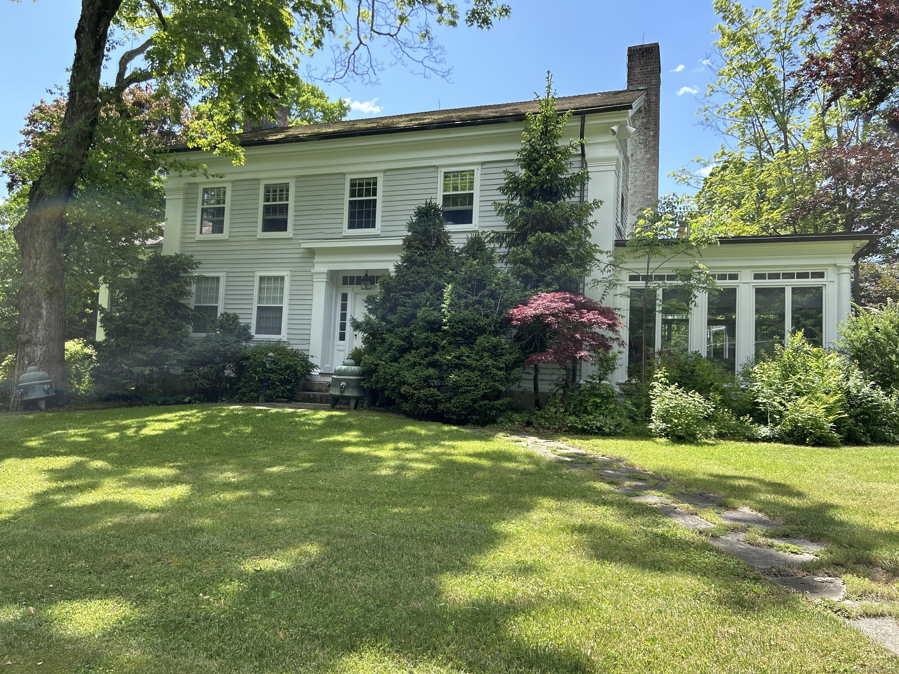 a front view of house with yard and green space