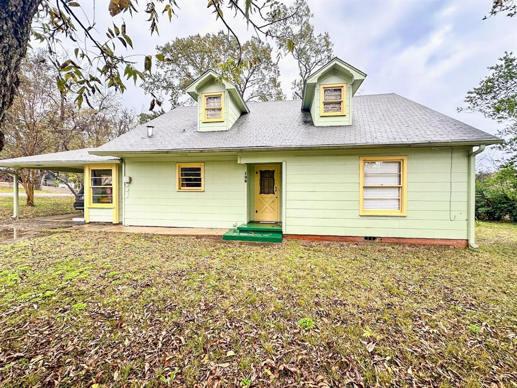 a house that has a tree in front of it