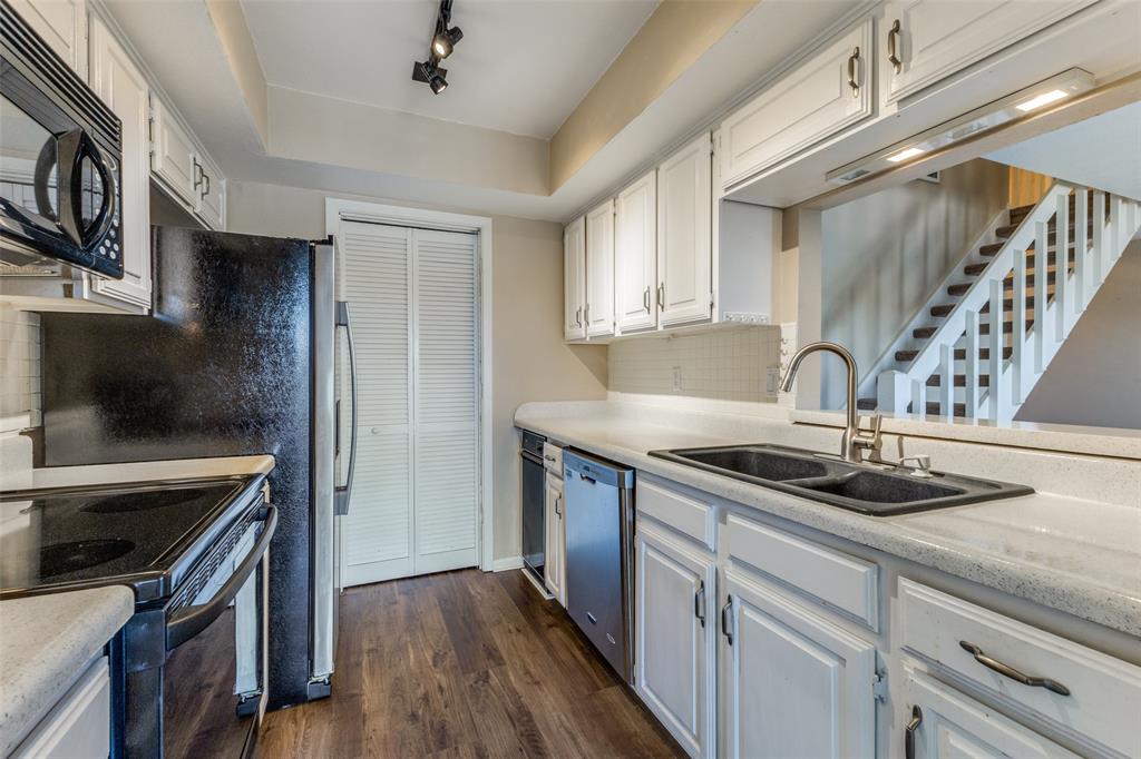 a kitchen with a sink and cabinets