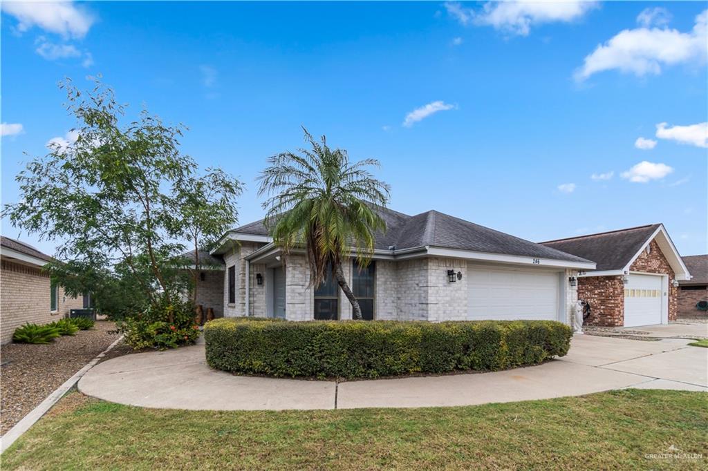 Single story home with a garage and a front yard