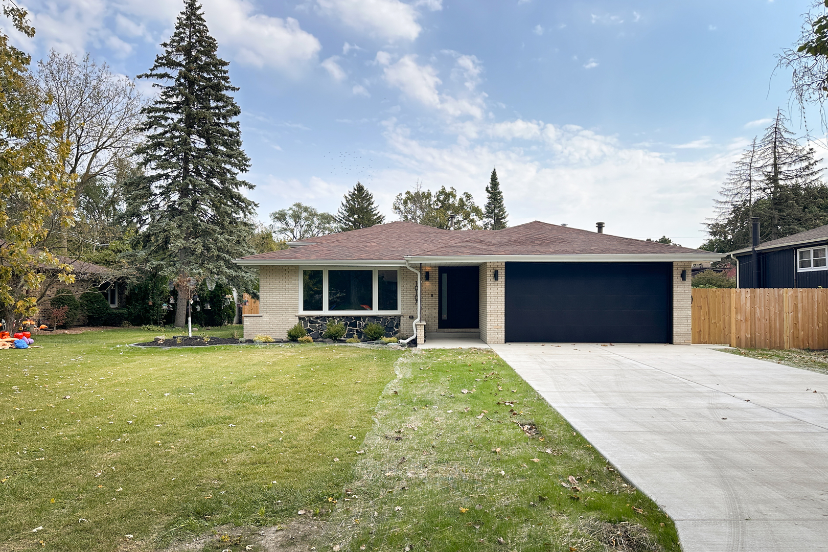 a front view of house with yard barbeque and outdoor seating