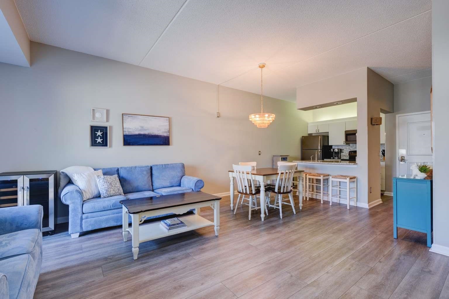 a living room with furniture and a wooden floor