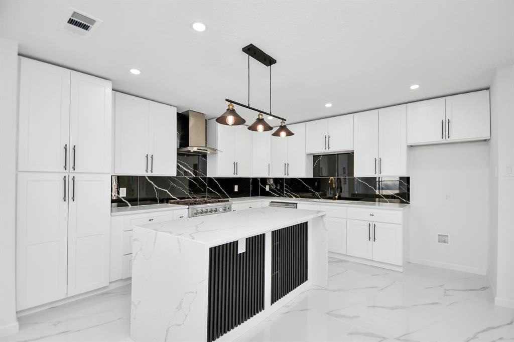 a kitchen with a sink a stove and refrigerator