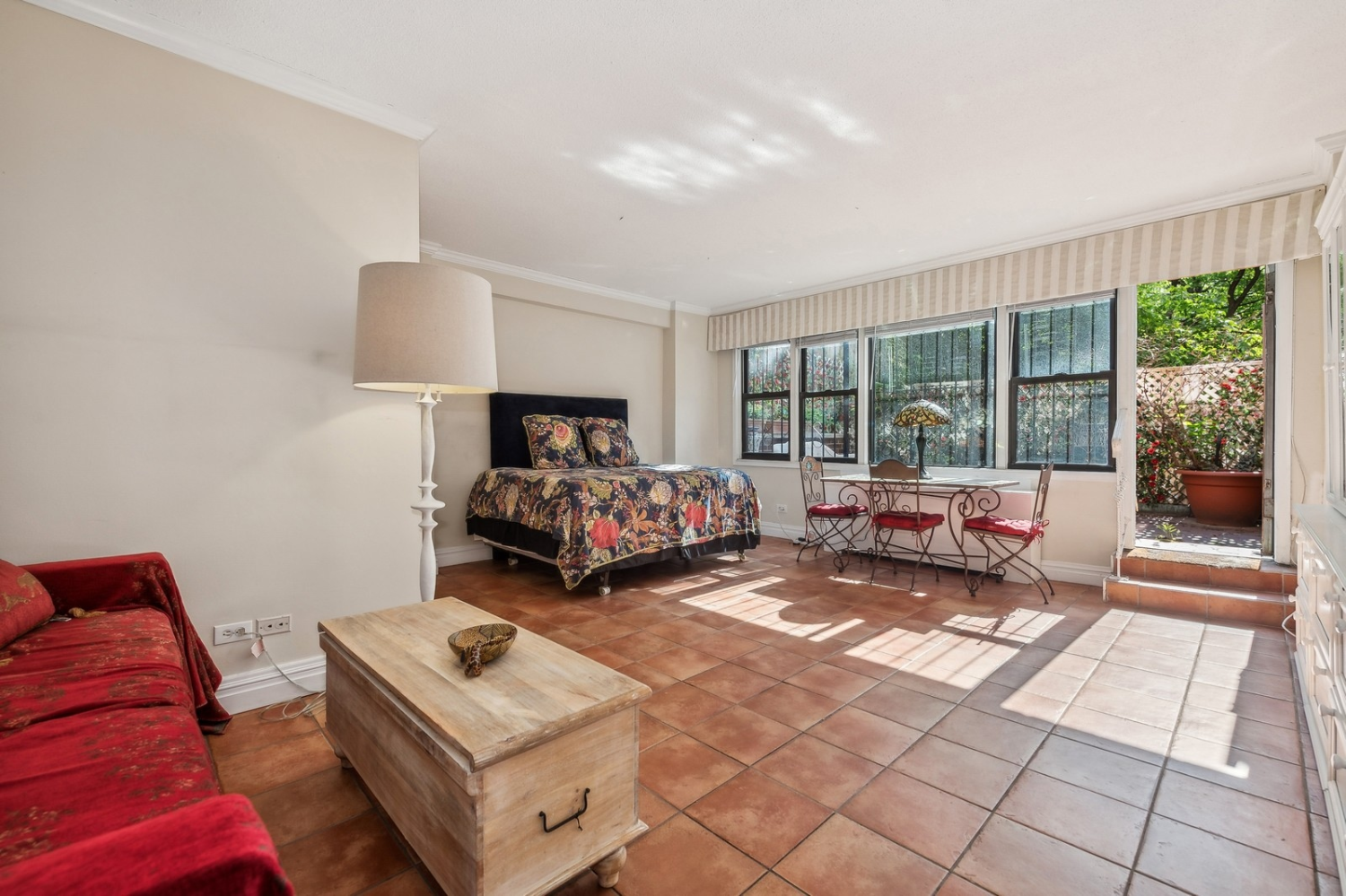 a bedroom with furniture and a large window