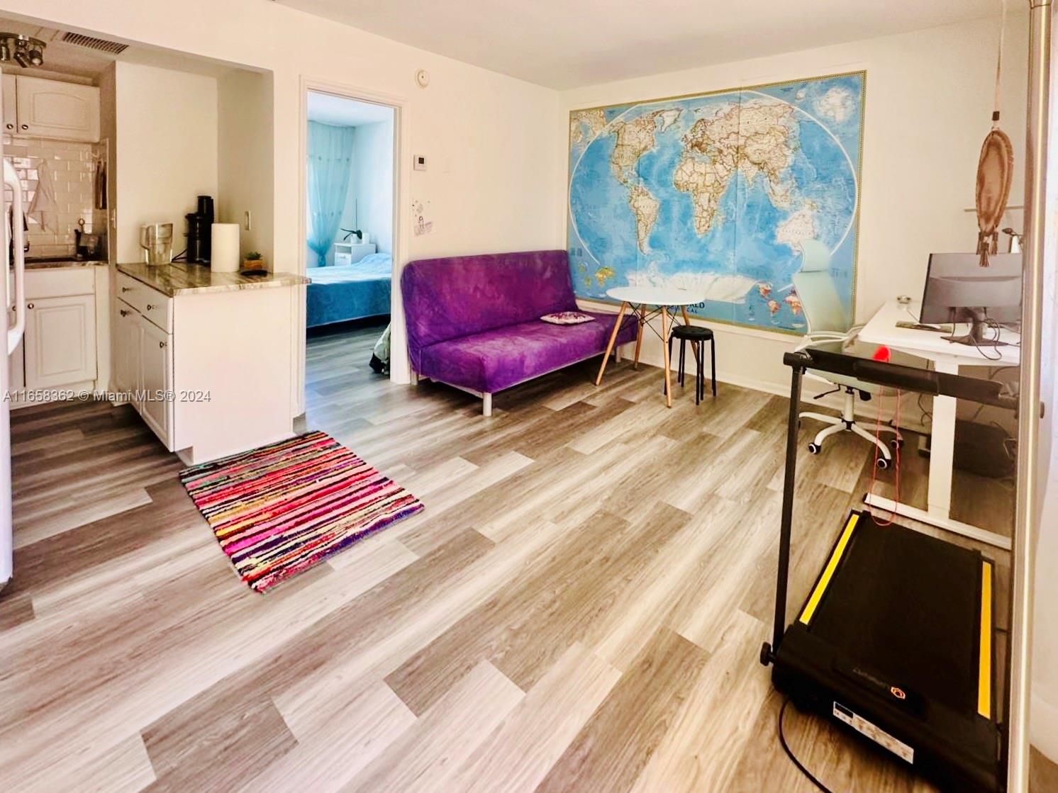 a living room with furniture rug and wooden floor