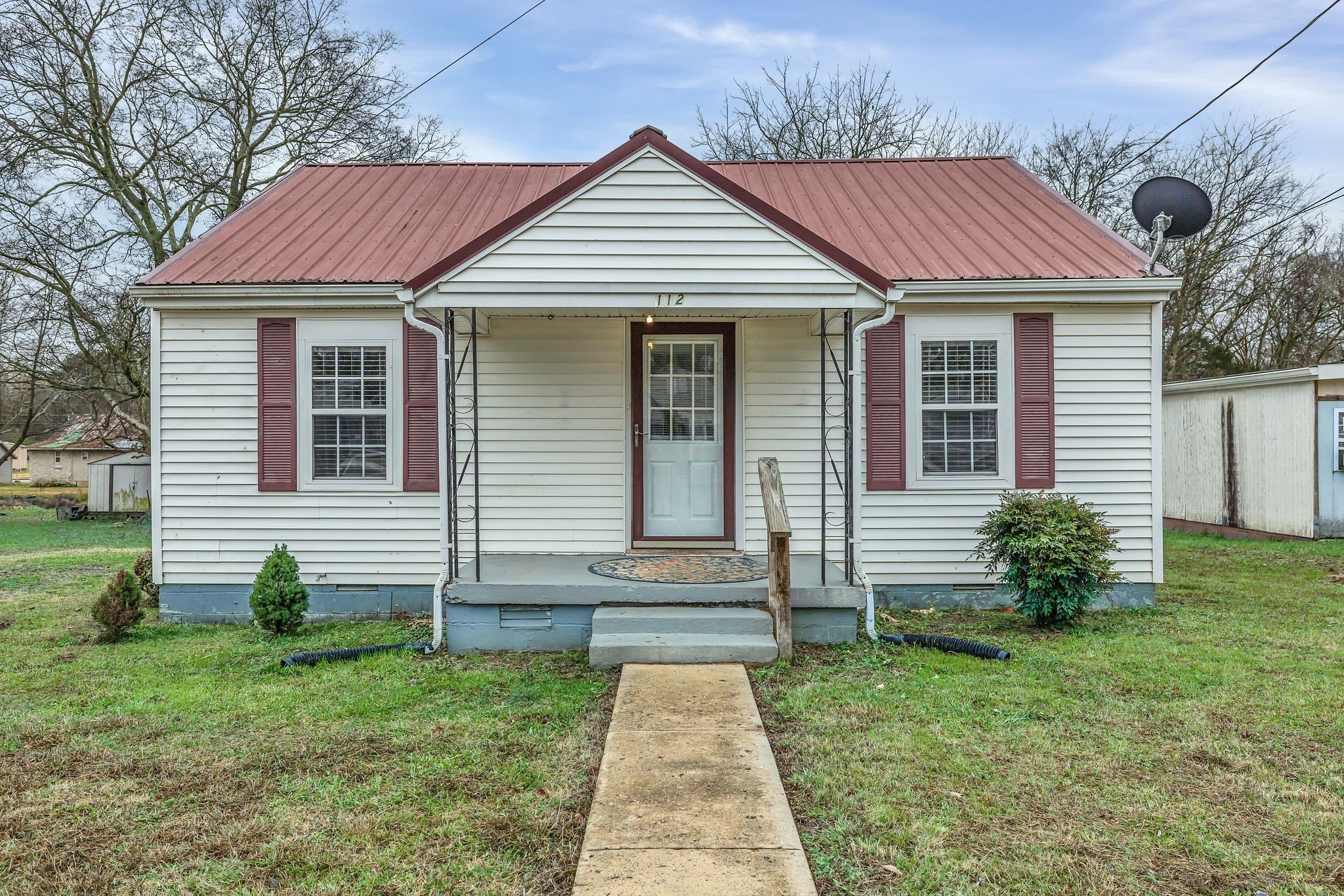 a front view of a house with a yard