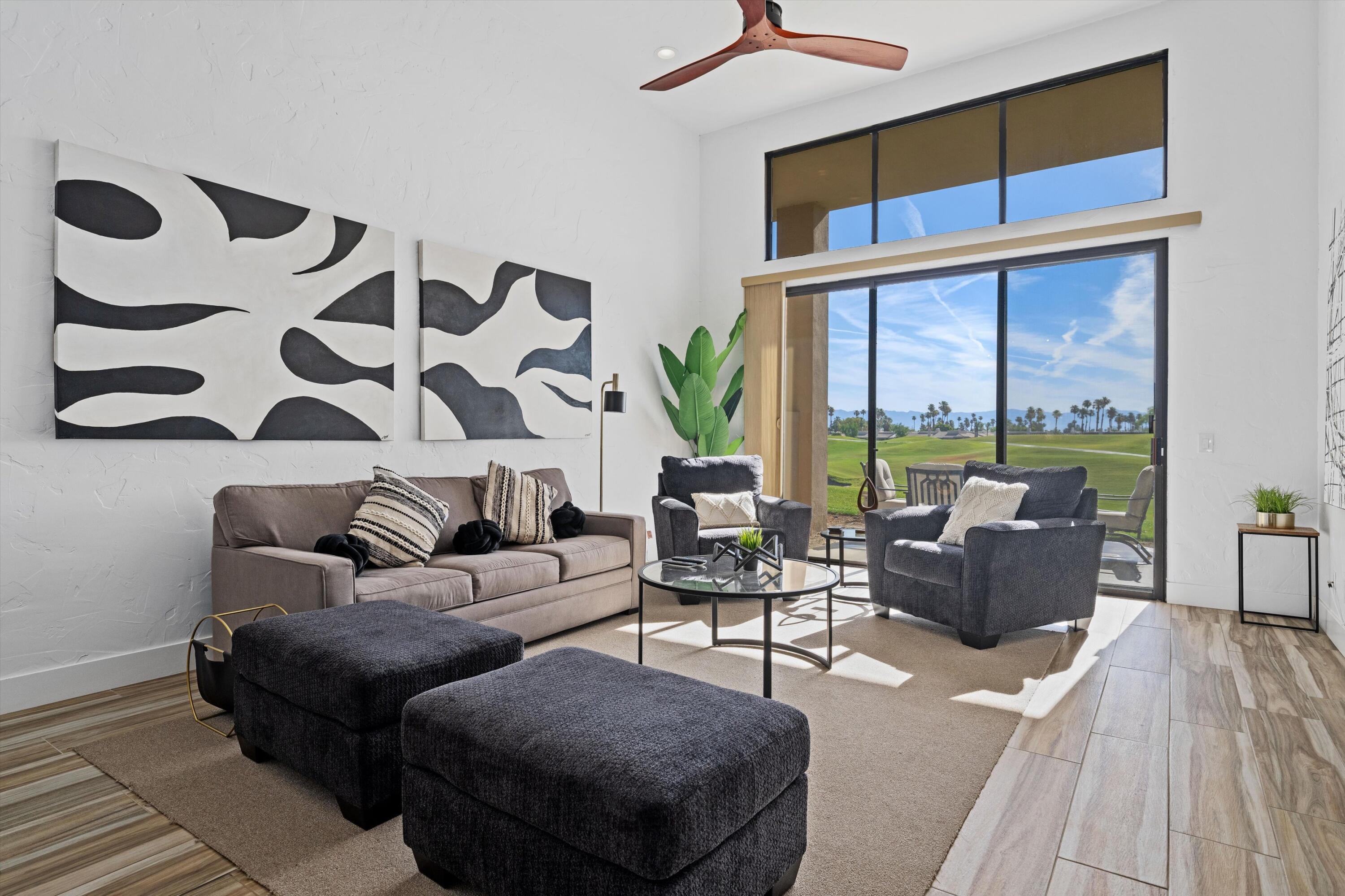 a living room with furniture and a large window