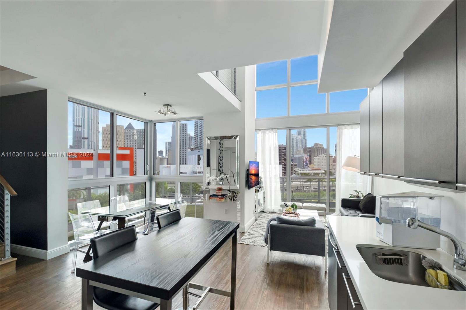 a kitchen with a table chairs stove and kitchen view