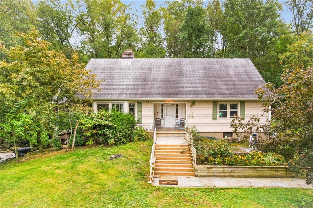 a aerial view of a house with a yard table and chairs