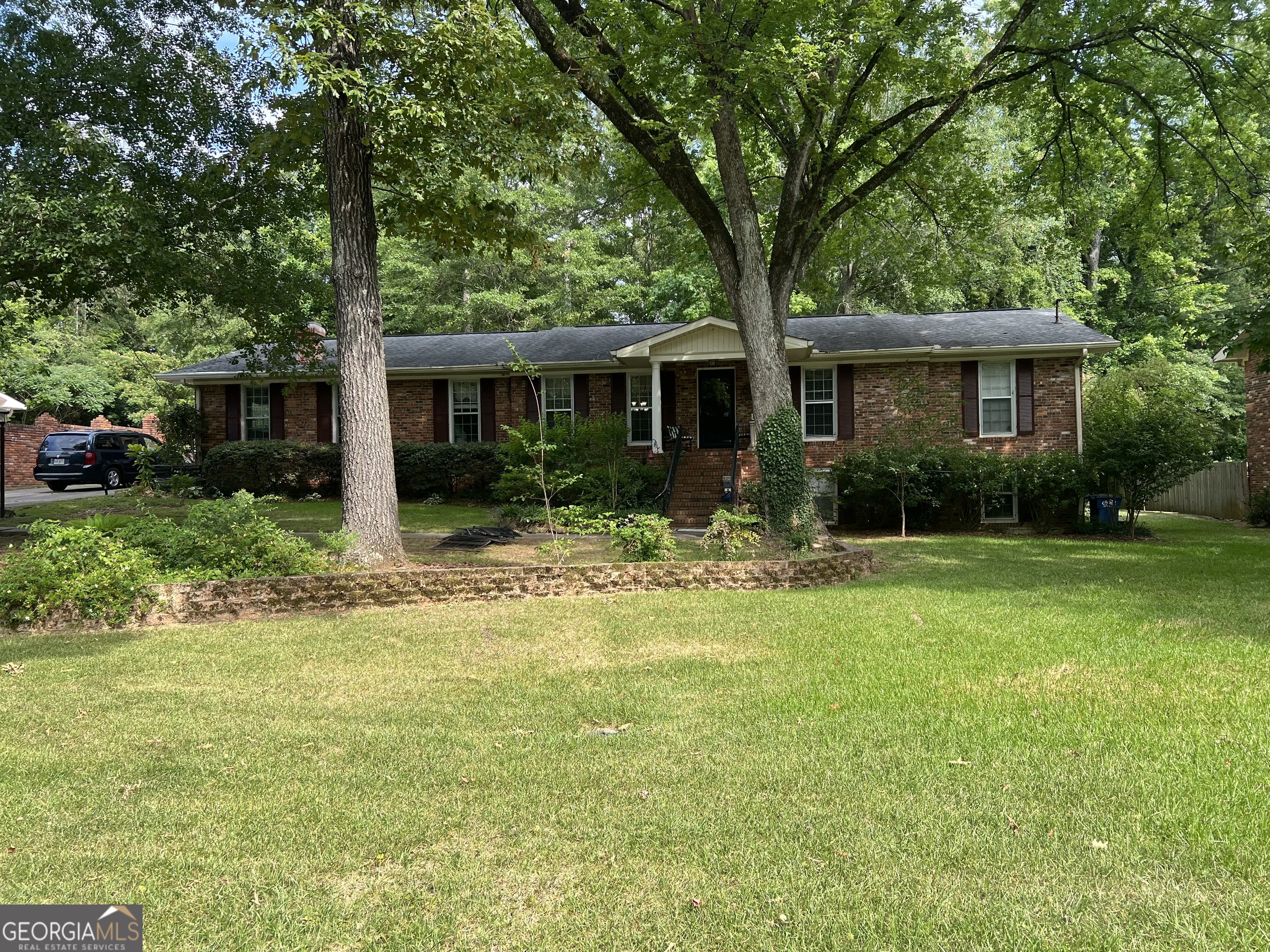 a front view of house with yard and green space