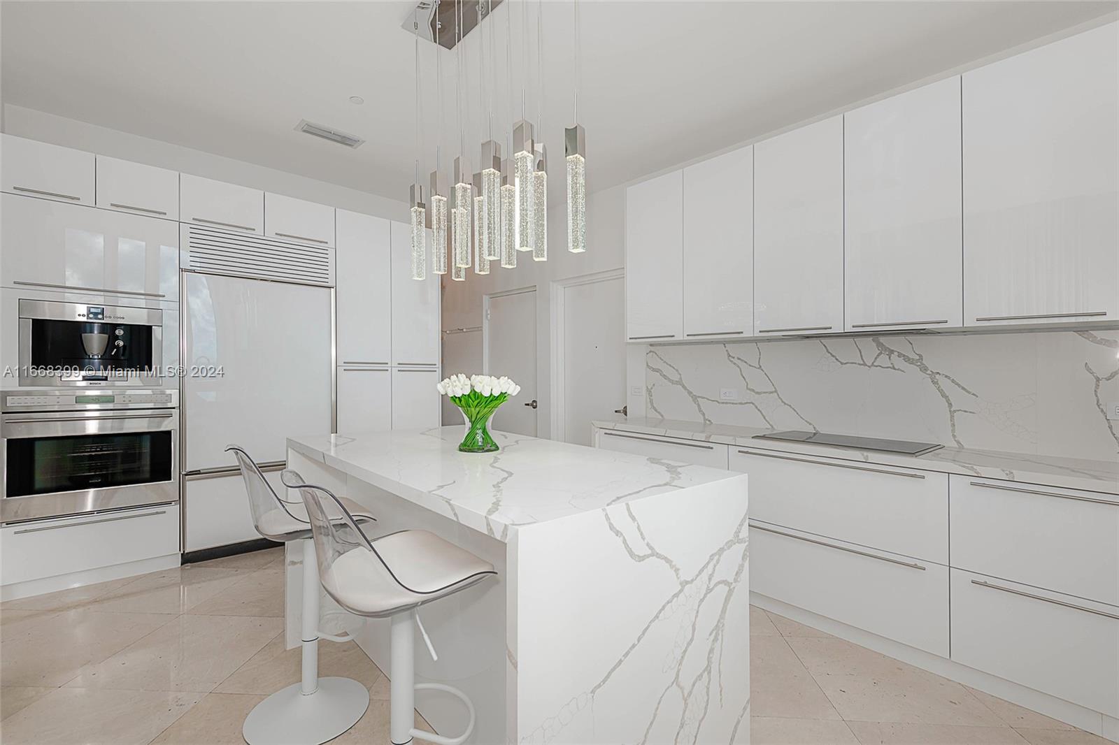 a kitchen with stainless steel appliances a sink a stove cabinets and a counter top space