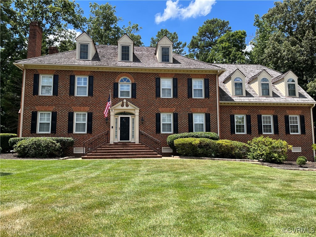 a front view of a brick house with a yard