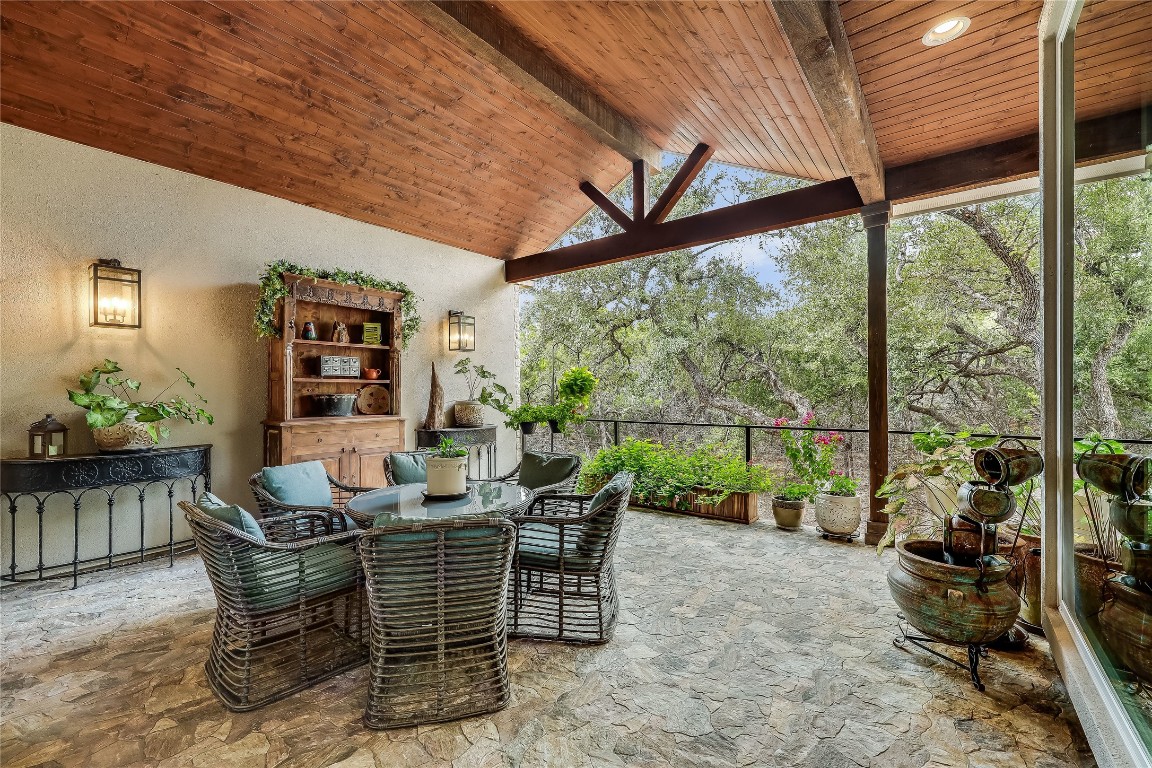 a dining room with furniture and a floor to ceiling window