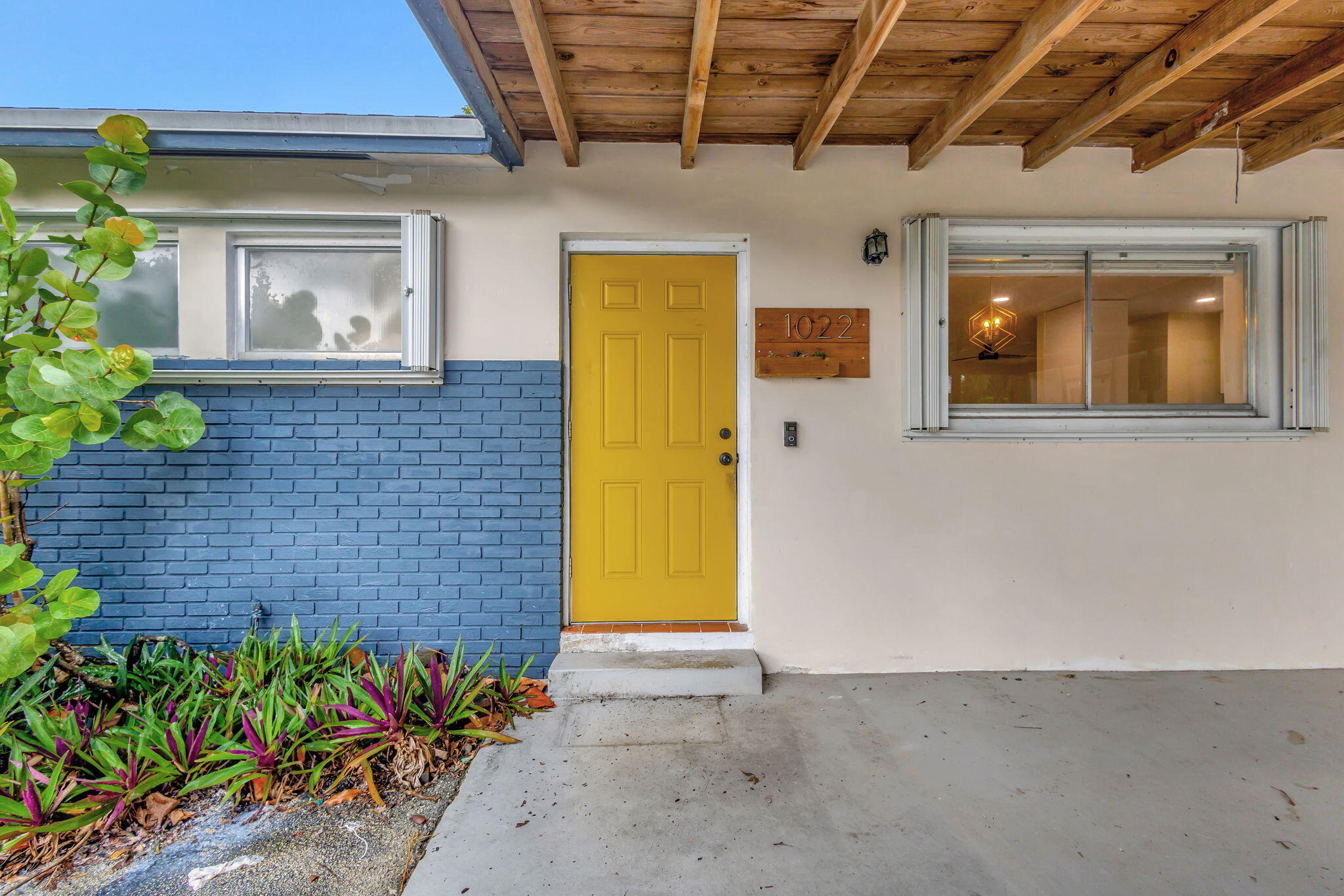 a view of front door of house with potted plant