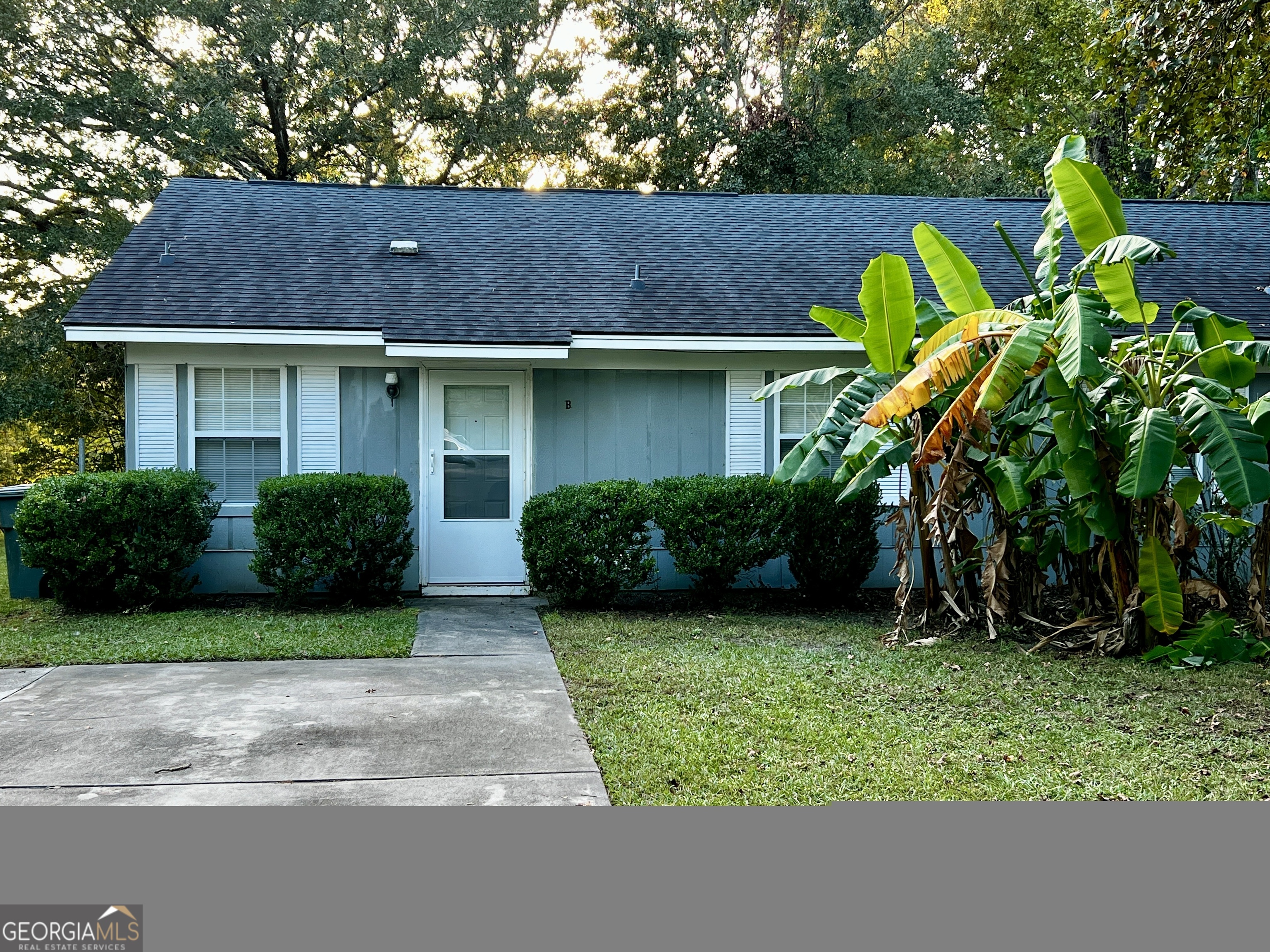 a view of a house with a yard and plants