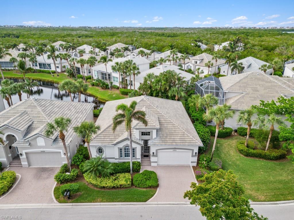 an aerial view of residential houses with outdoor space and river