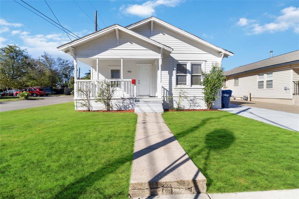 a front view of a house with garden and porch