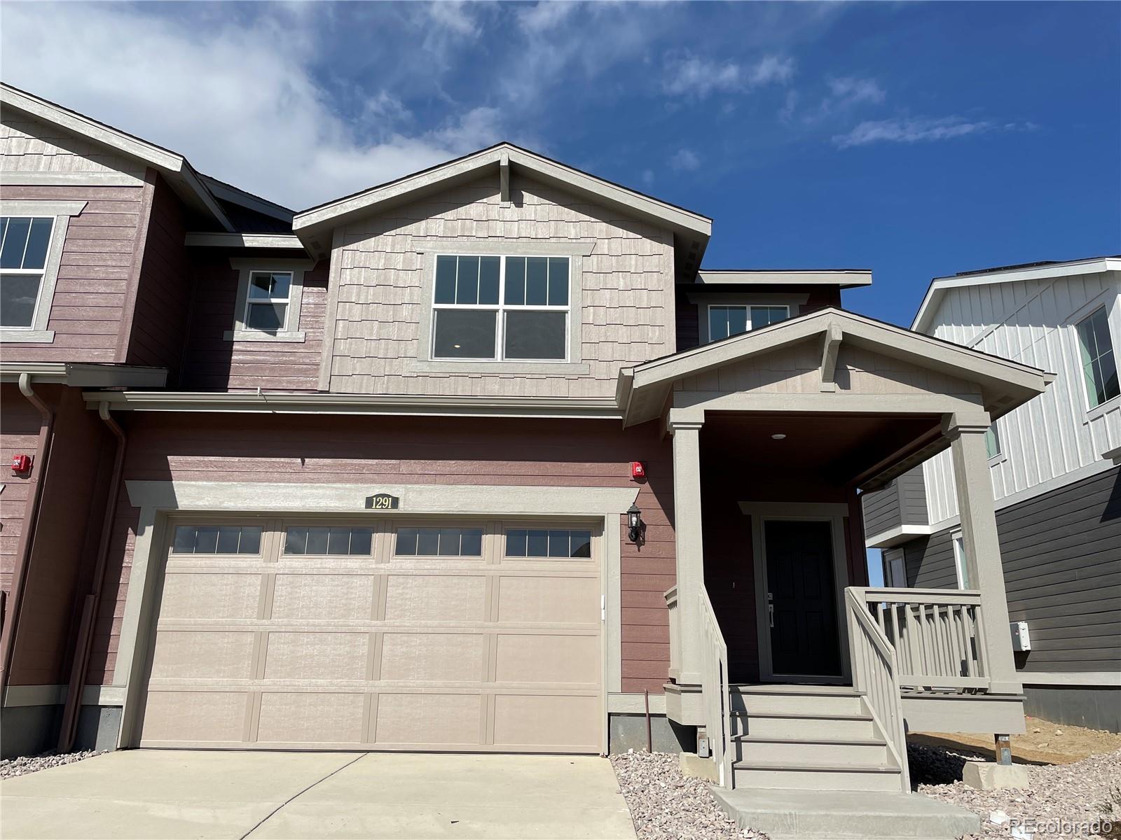 a front view of a house with parking