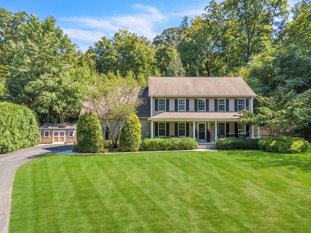 a front view of a house with a garden