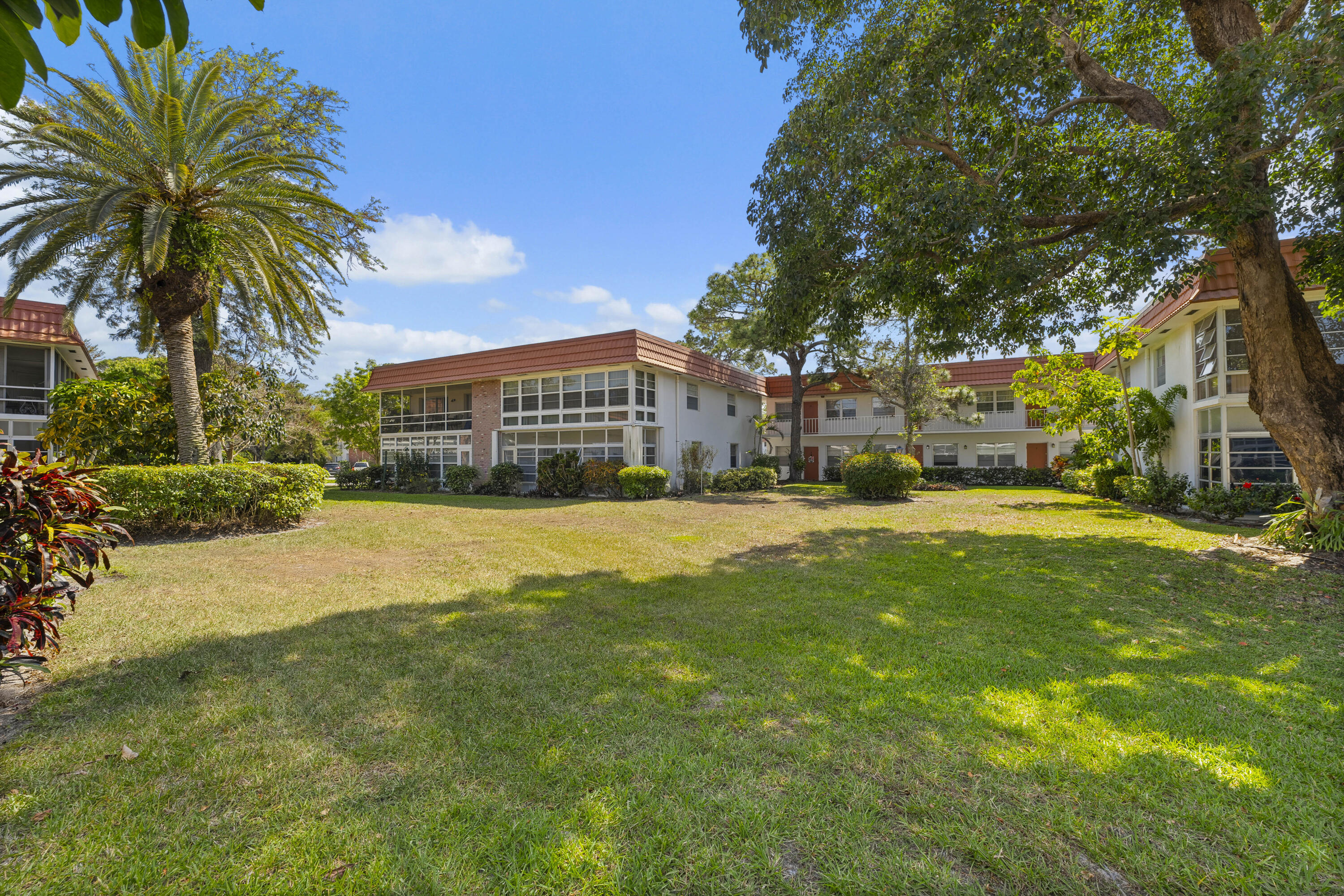 a view of swimming pool with outdoor seating and house in the background