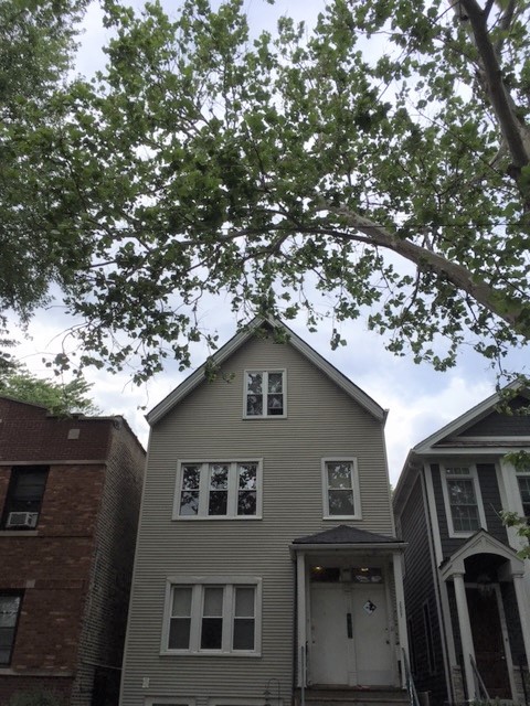 a house view with a tree in the background