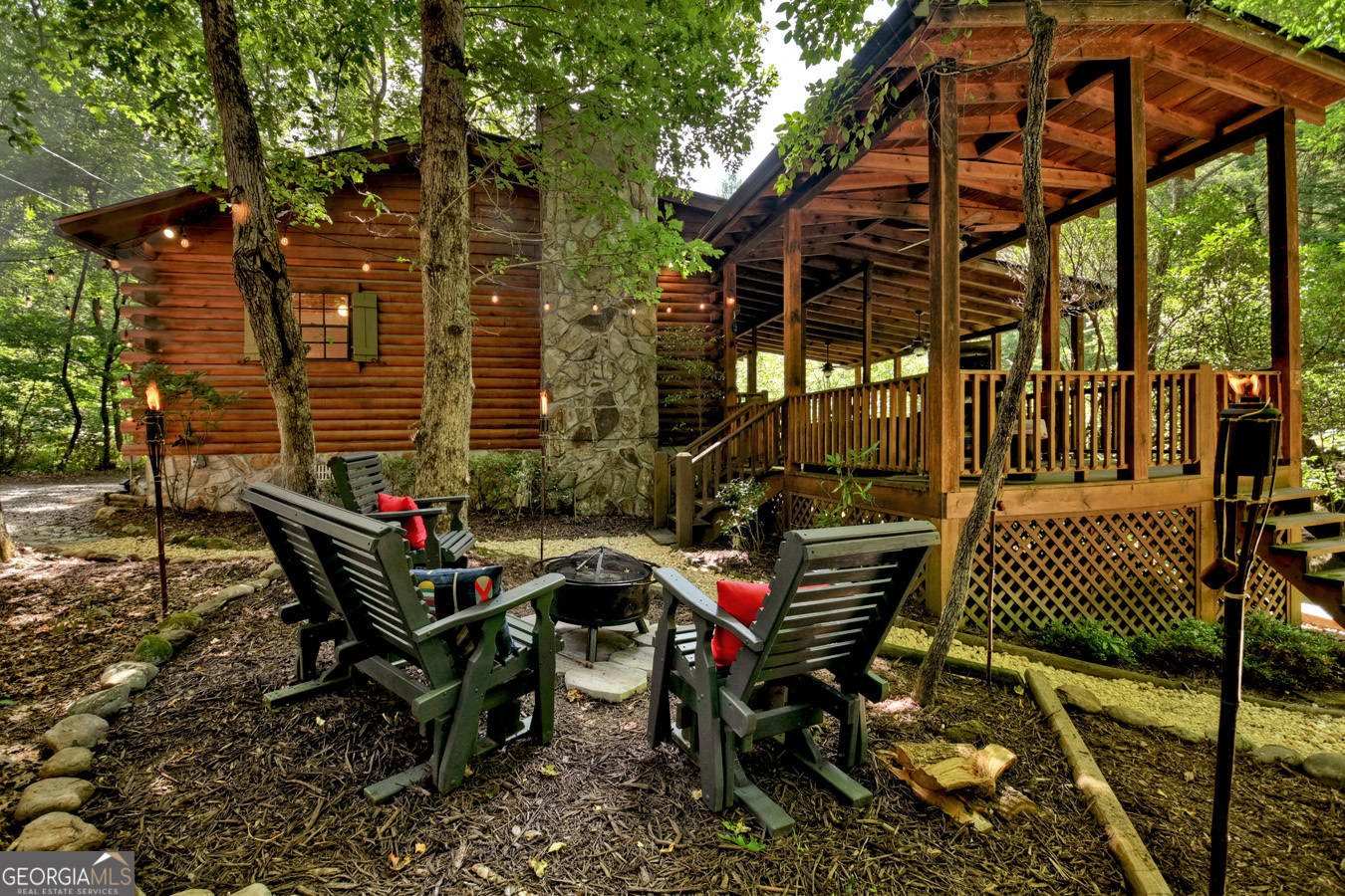 a view of a chairs and table in the backyard