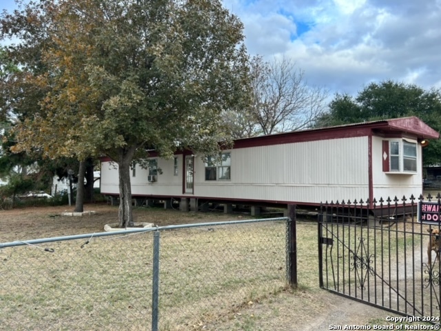 a view of a house with a backyard