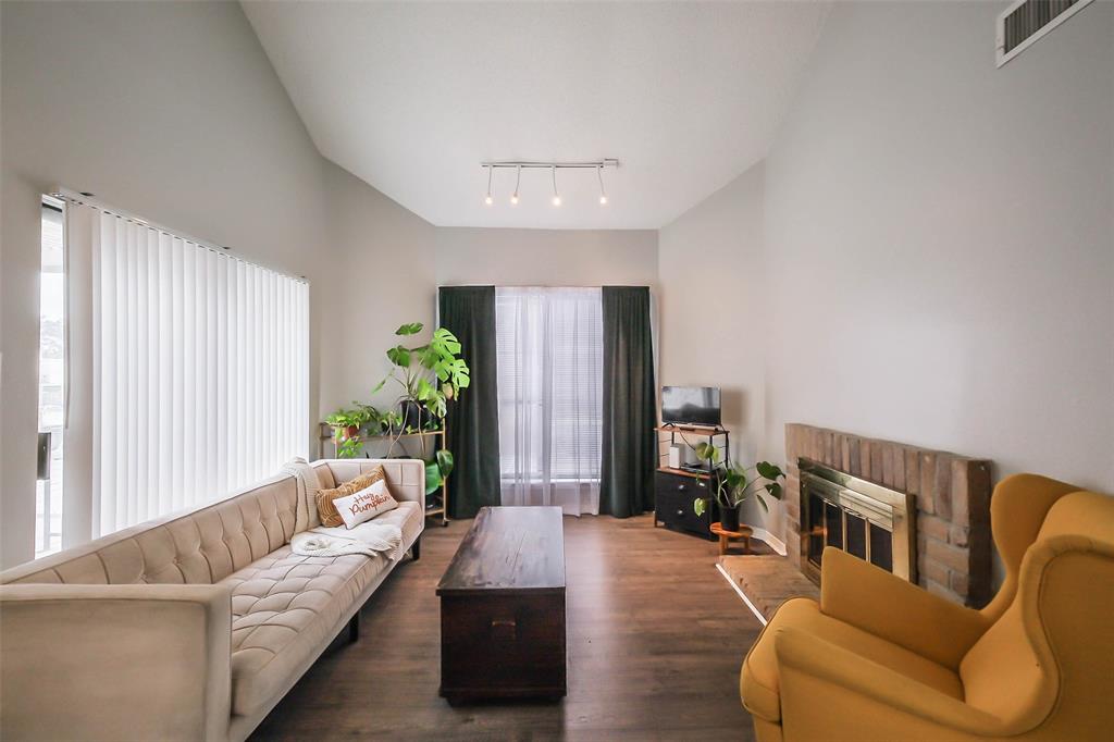 What an inviting living space with high ceilings and filled with natural light