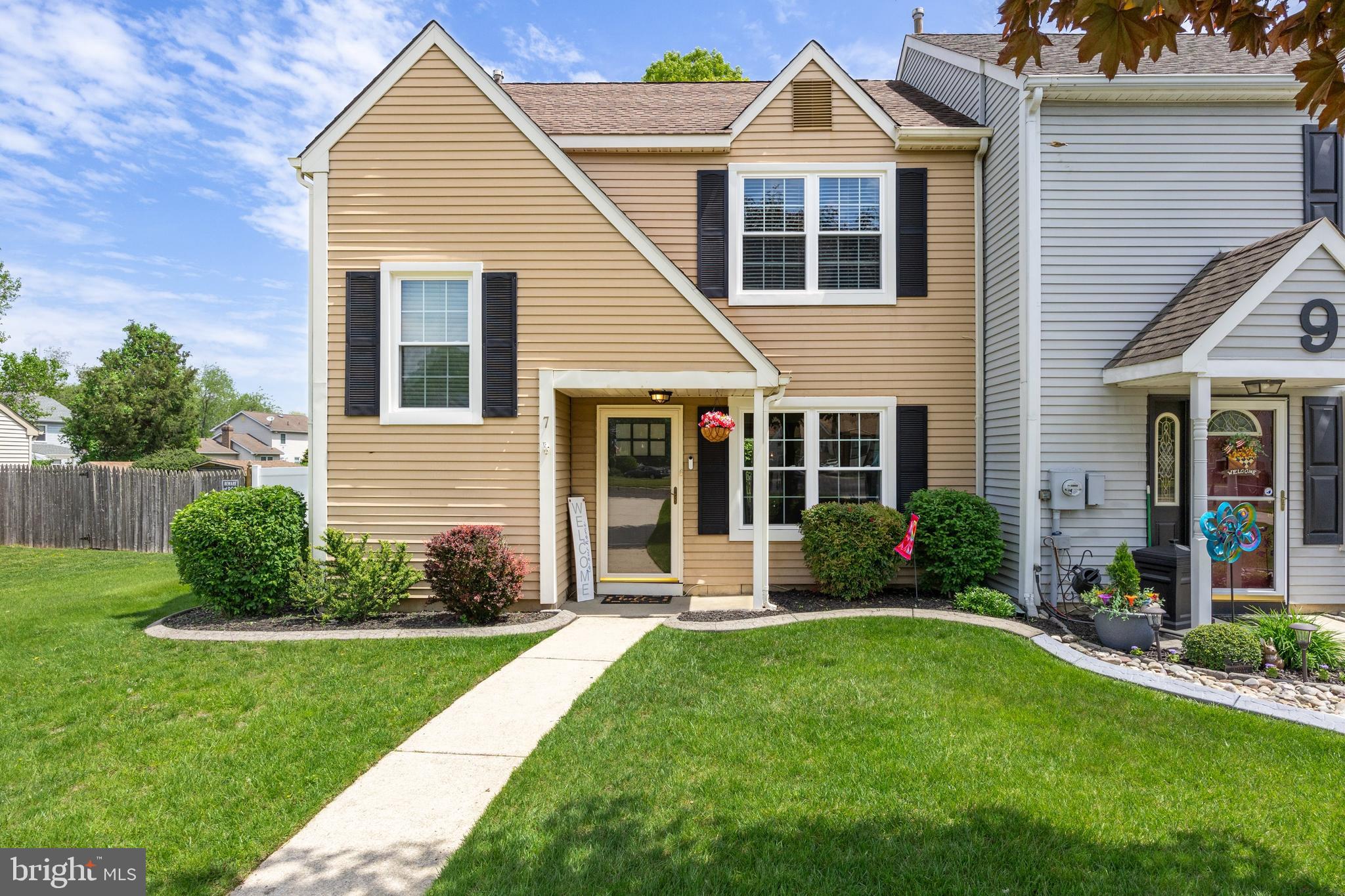 a front view of a house with a yard and porch