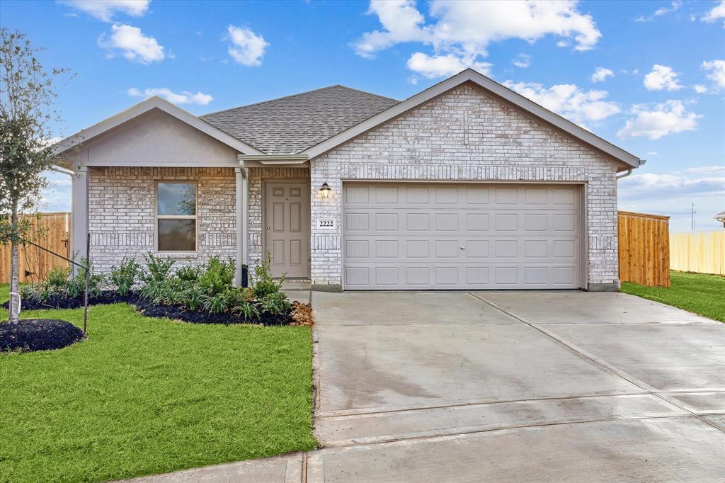 a front view of house with yard and garage