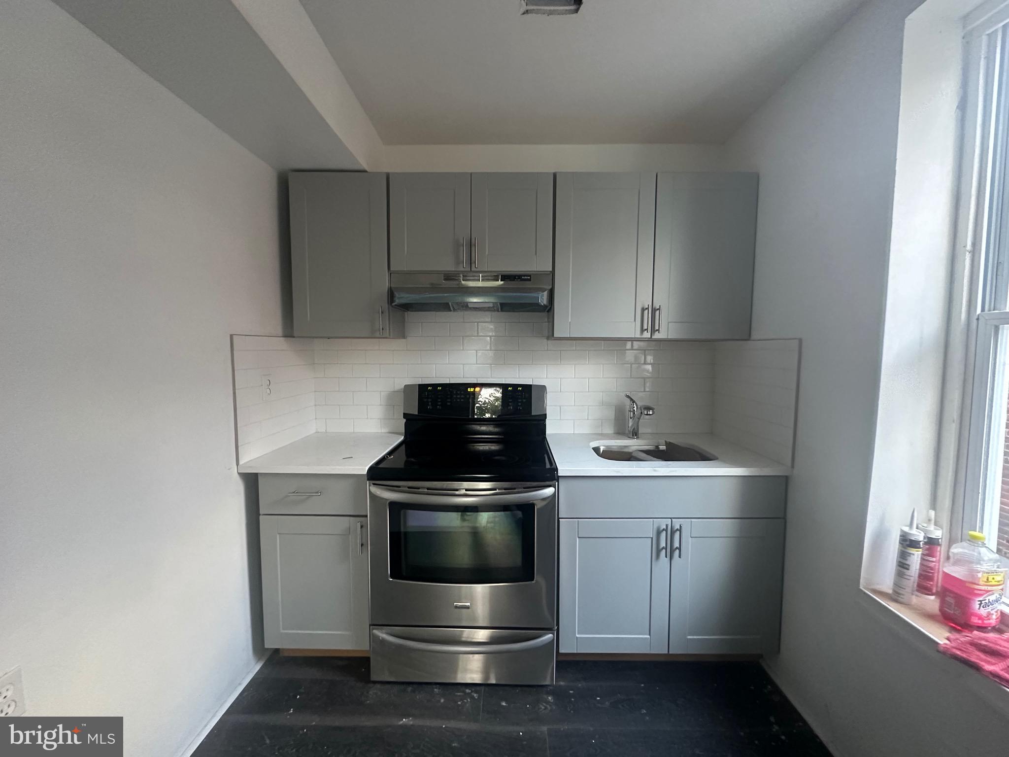 a kitchen with a stove and a sink