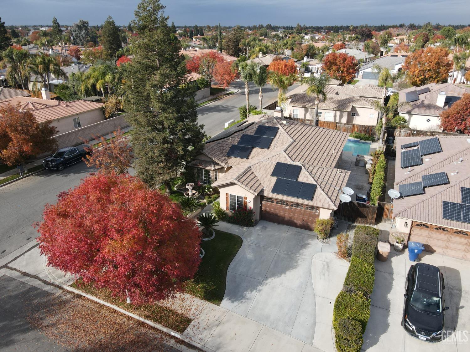 an aerial view of a house with a yard and garden