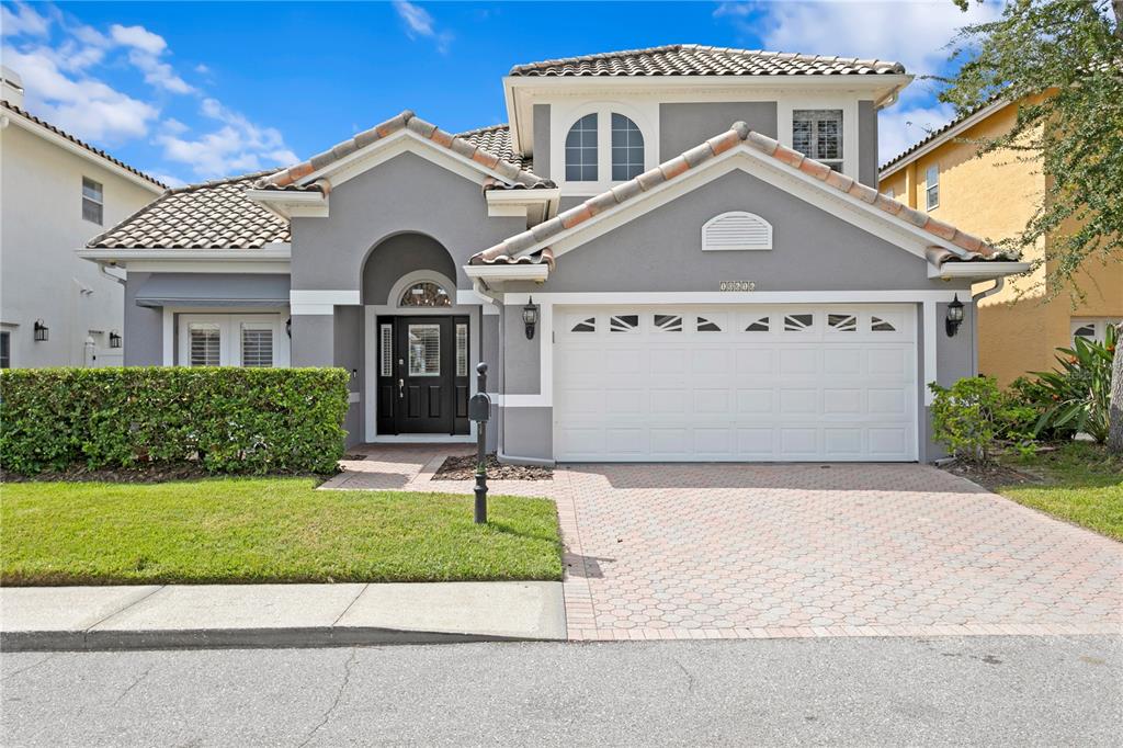 a front view of a house with a yard and garage