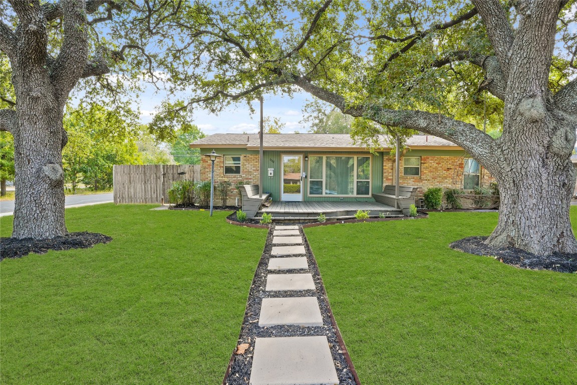 a front view of a house with a yard table and garden