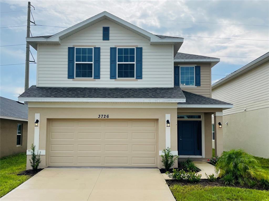 a front view of a house with a yard and garage