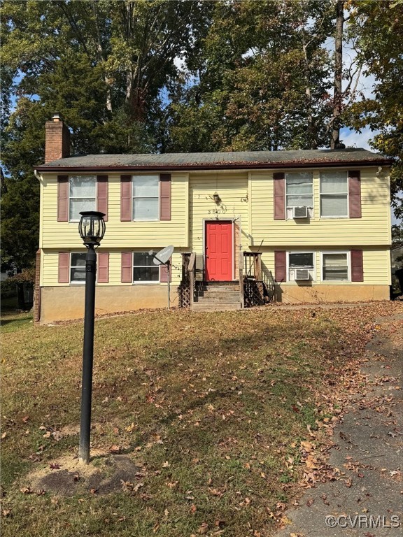 Split foyer home with cooling unit and a front law