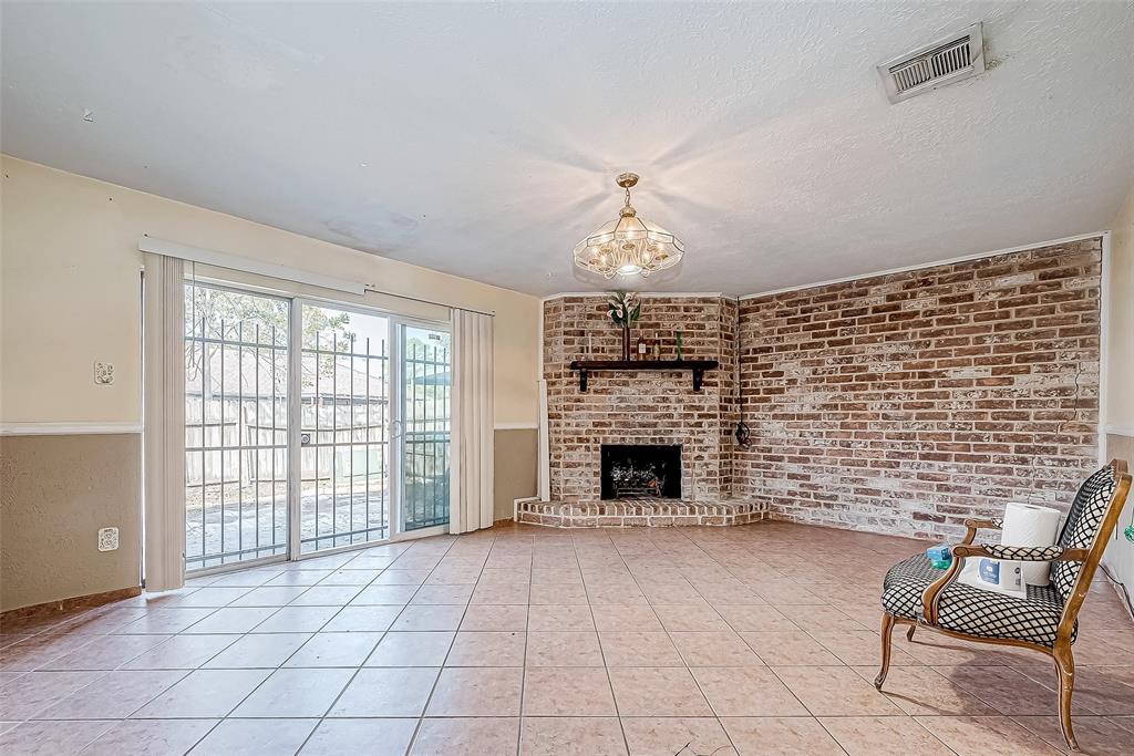 an empty room with furniture and fireplace