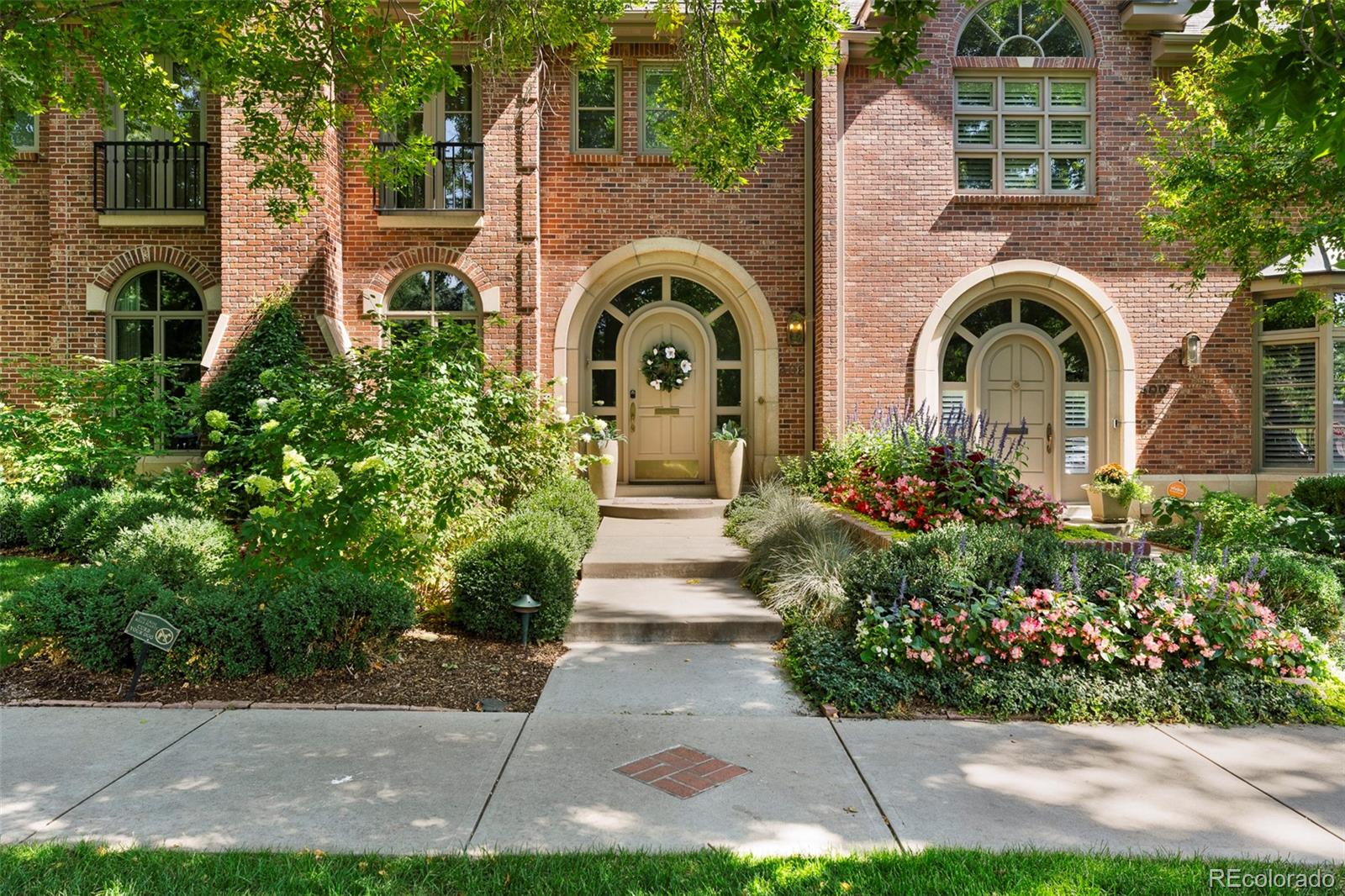 a front view of a house with garden