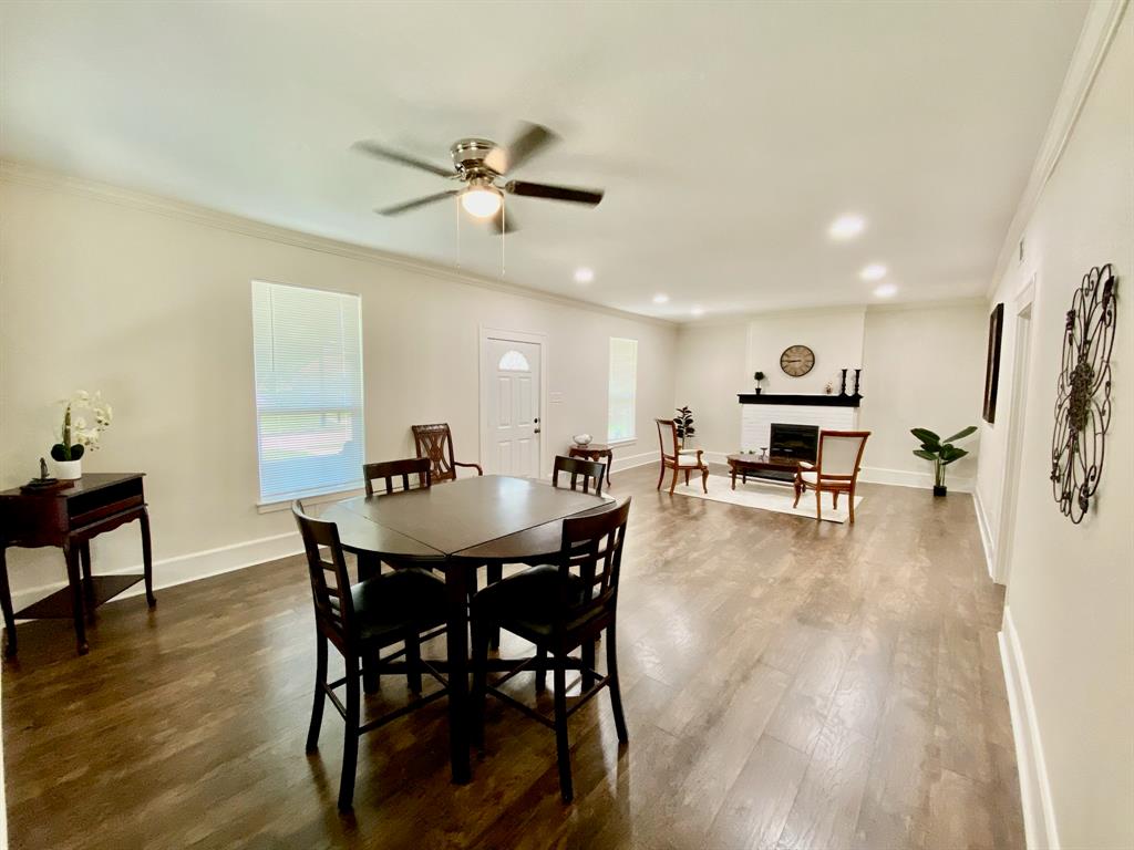 a view of a dining room with furniture and wooden floor