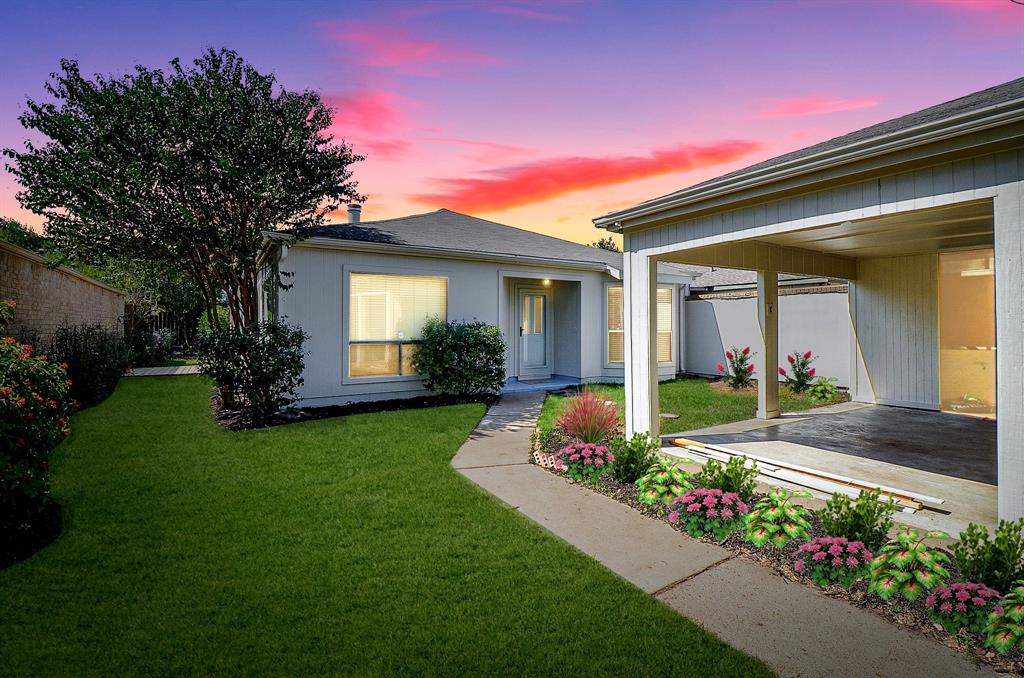 Gorgeous convenient fully fenced patio home. This photo is virtually enhanced with a twilight sky and virtual flowers.