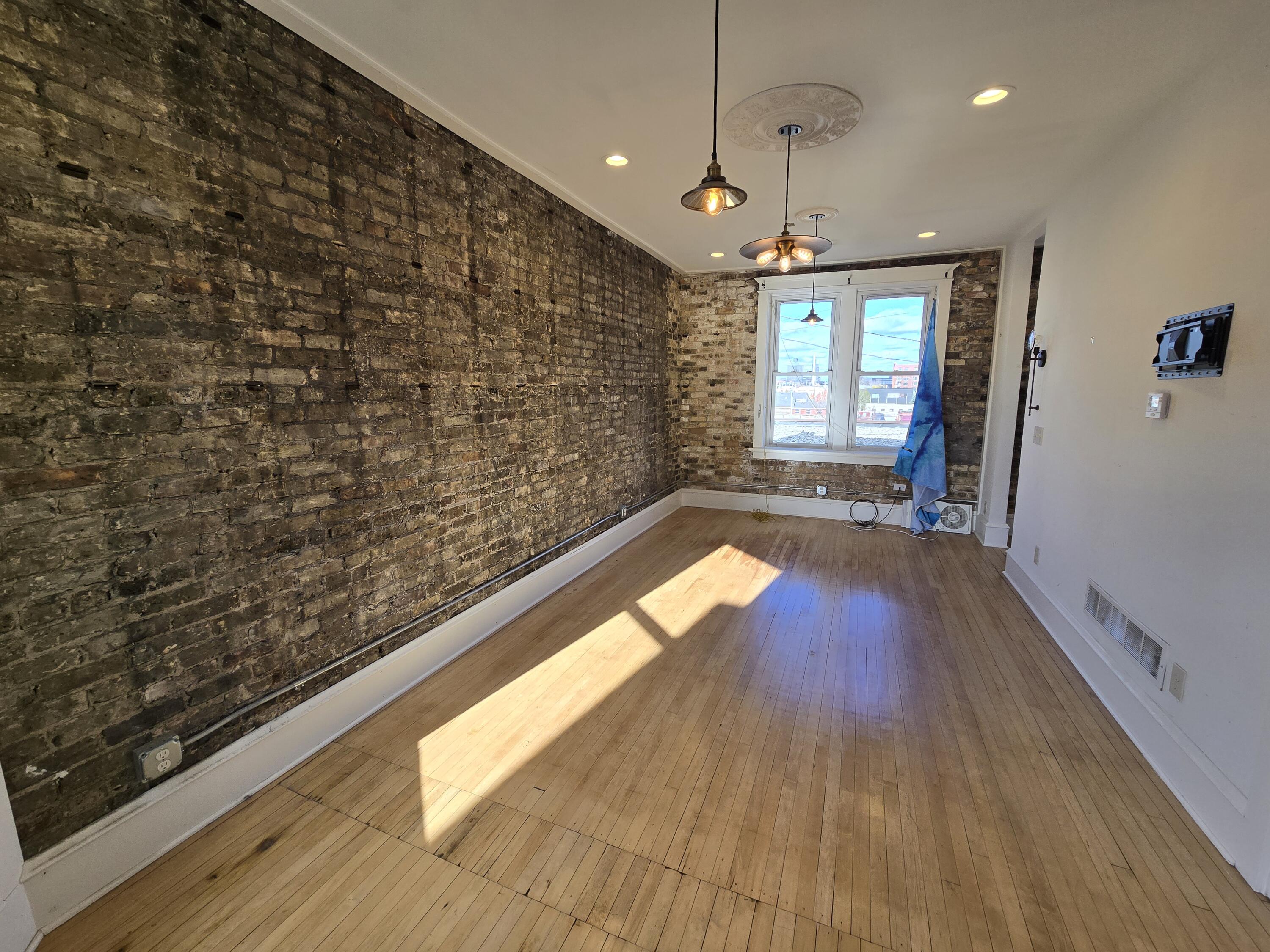 Exposed Brick & Hardwood Floors