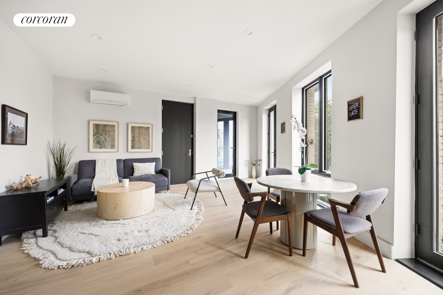 a living room with furniture and wooden floor