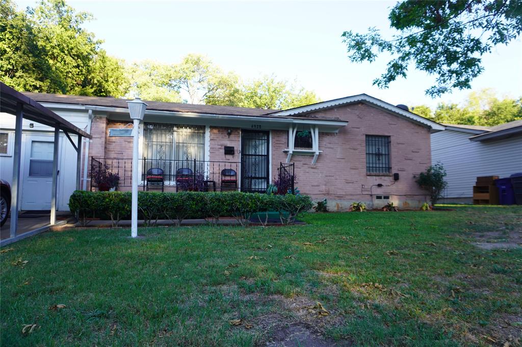 a brick house with garden in front of it