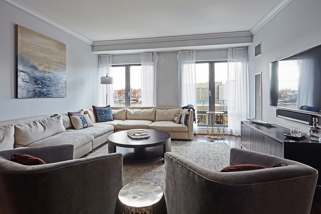 a living room with furniture and a potted plant