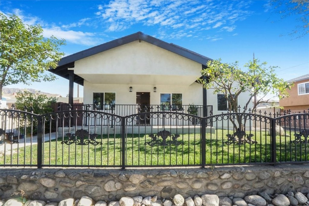 a front view of a house with a garden