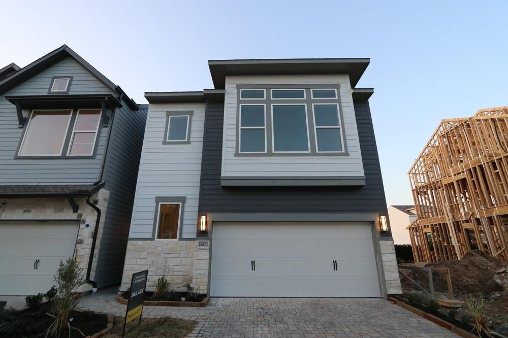 a front view of a house with garage