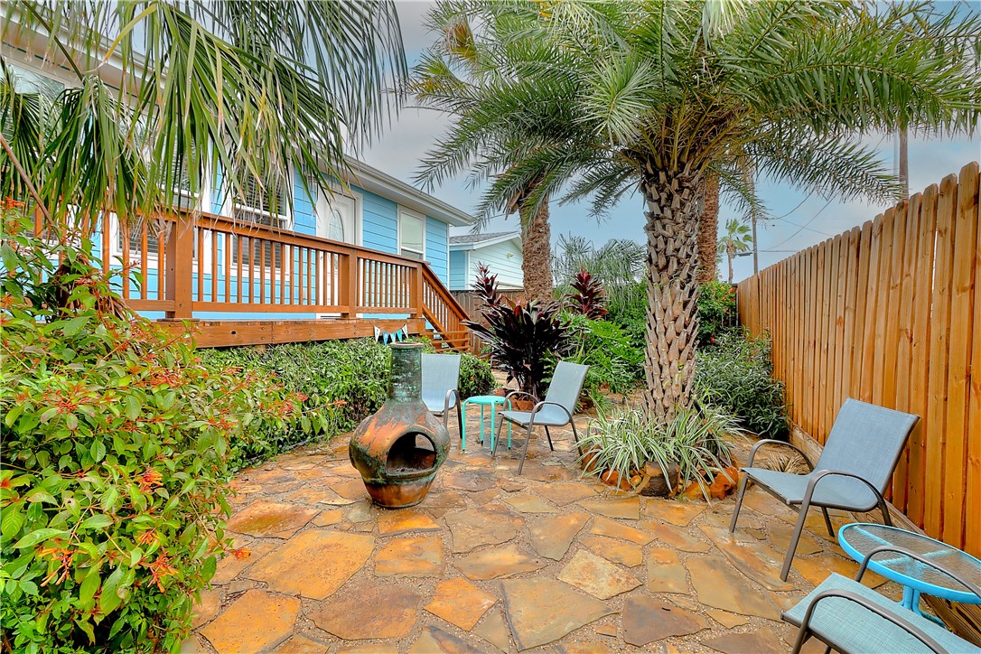 a backyard of a house with barbeque oven table and chairs