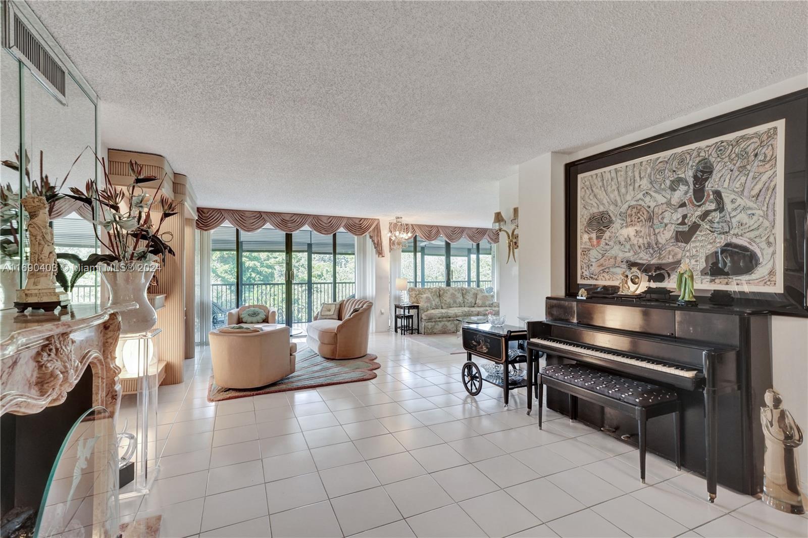 a living room with furniture a large window and a flat screen tv