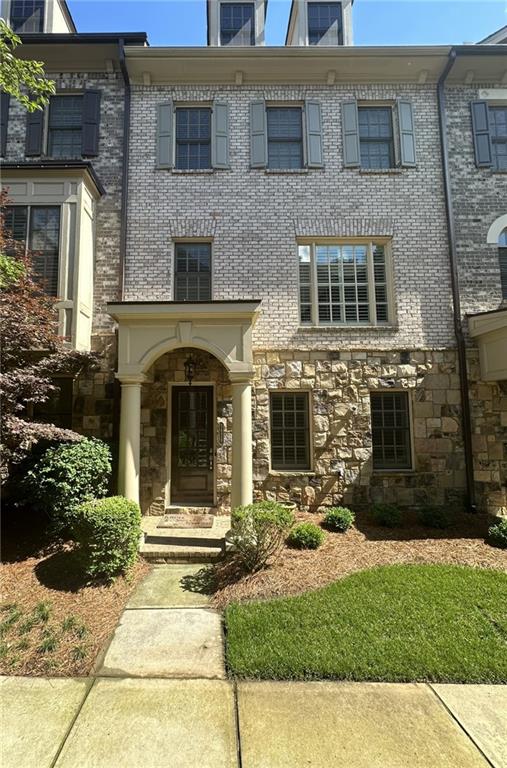 a front view of a house with garden