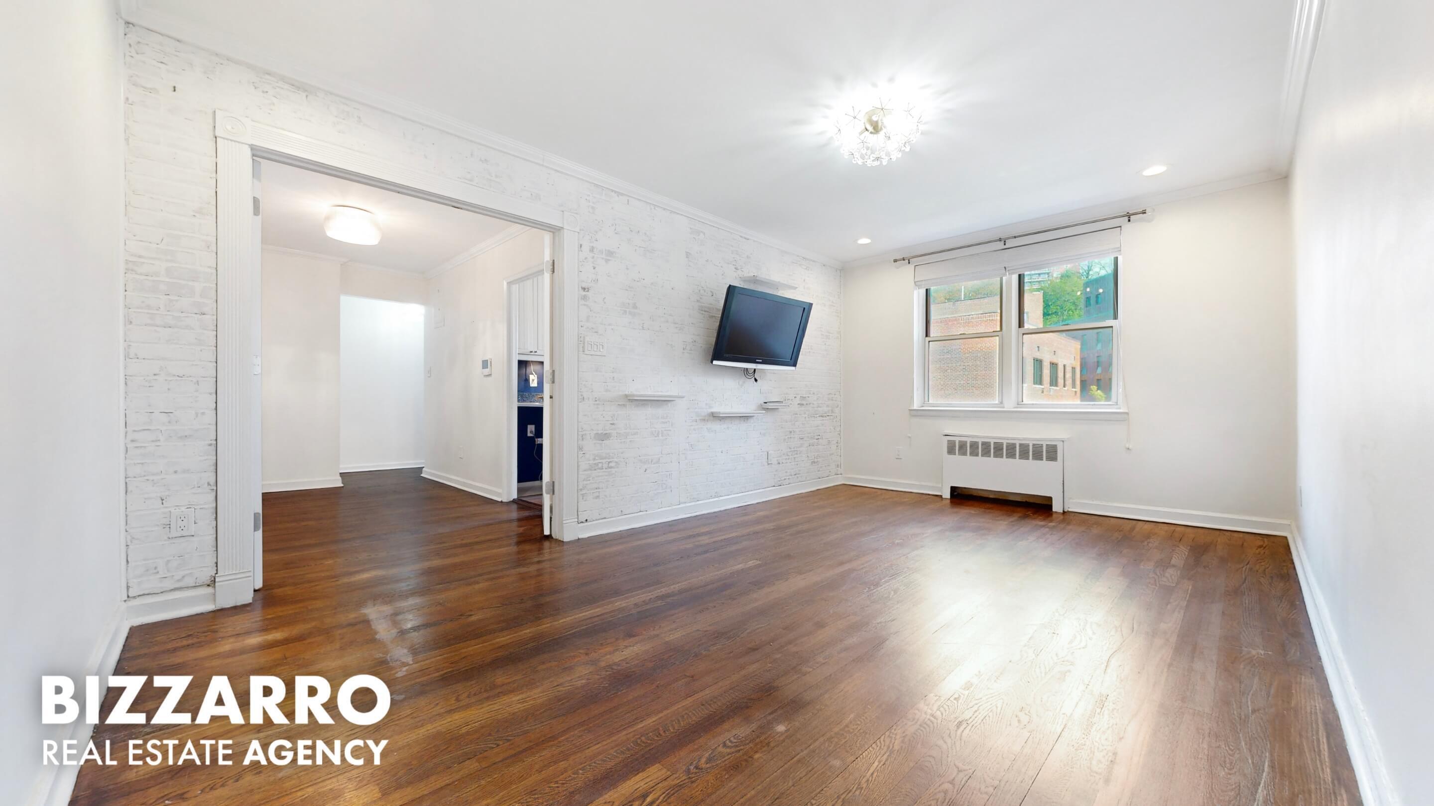 wooden floor in an empty room with a window